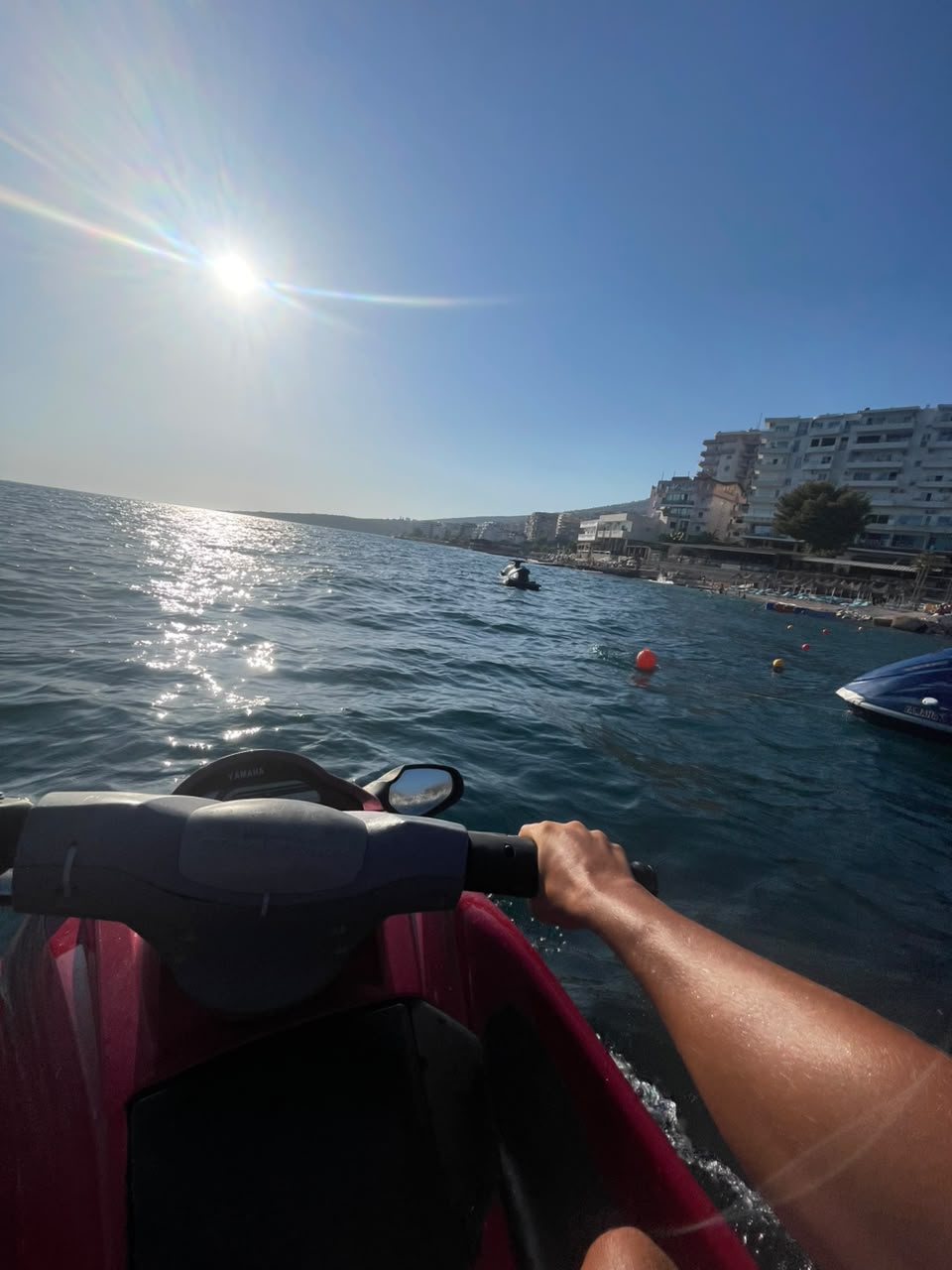 Sarandë promenade seen from a jet ski on the Ionian Sea at midday